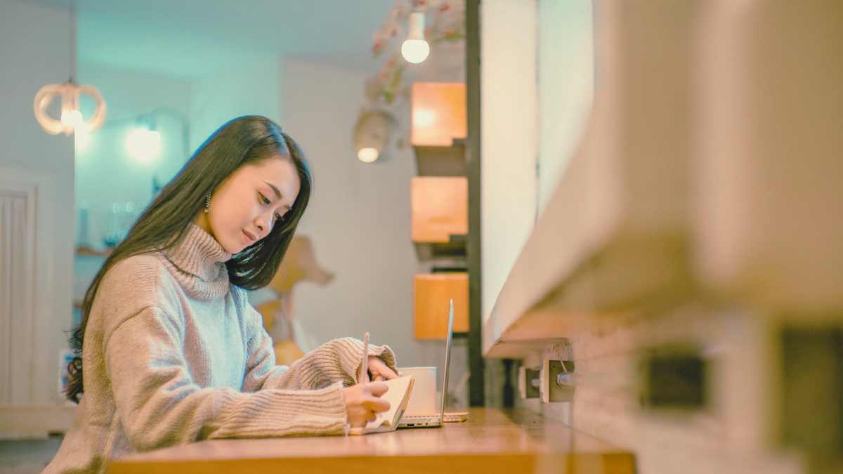 How Your Brain Separates Talking Ability From Writing Ability - woman writing indoors at her desk